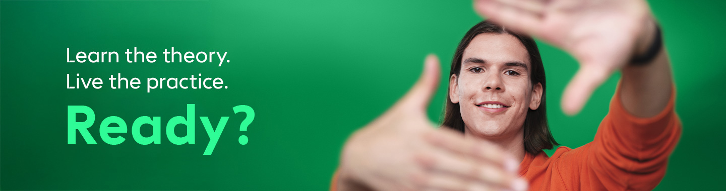 A young man smiles at the camera and extends his hands invitingly.